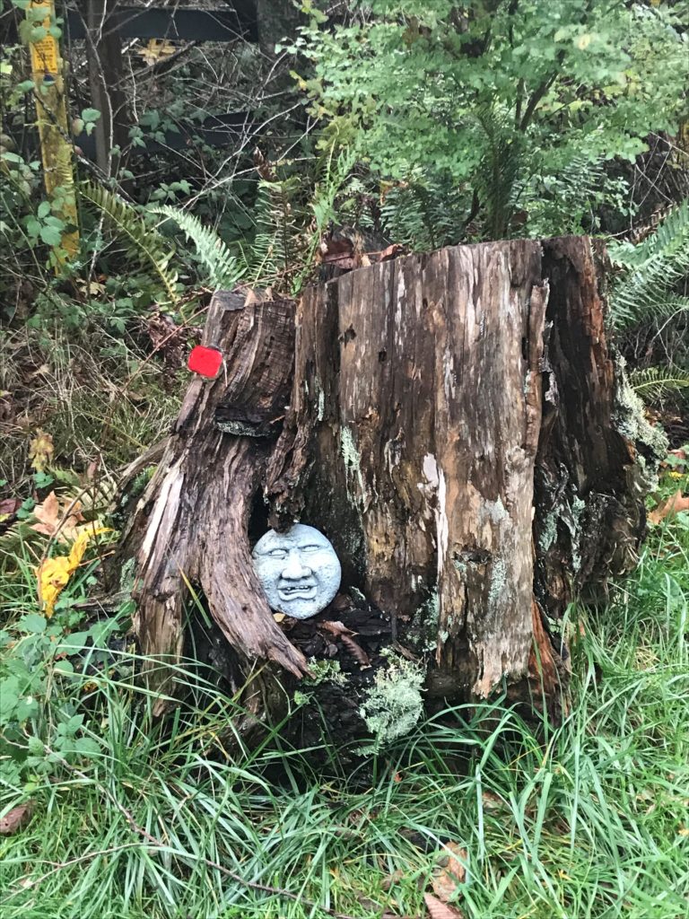 Sculpted stone face set into a stump